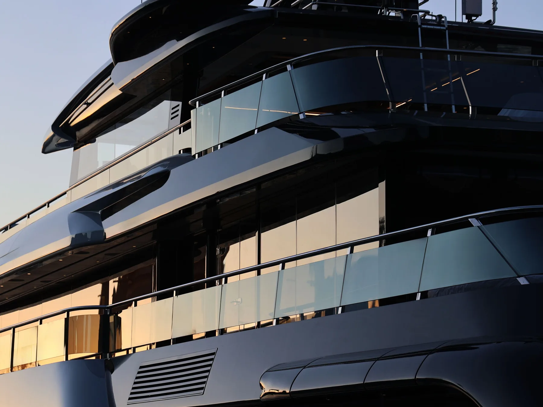 Architectural detail of a large modern superyacht at sunset